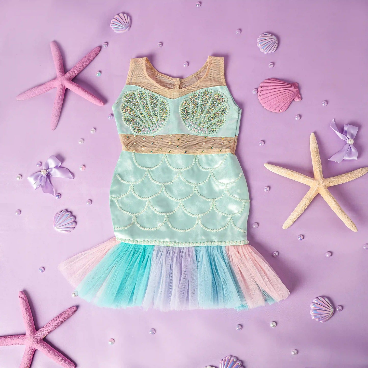Mermaid-themed dress with starfish and shells on a purple background