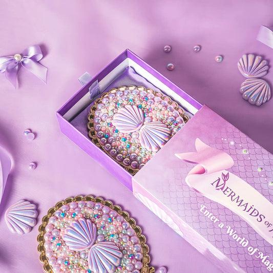 Decorative plates with shell design in a 'Mermaids of a World of Magic' box on a purple background.