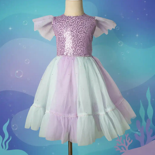 Children's dress with pink and white ruffled sleeves on a mannequin against an underwater-themed background.