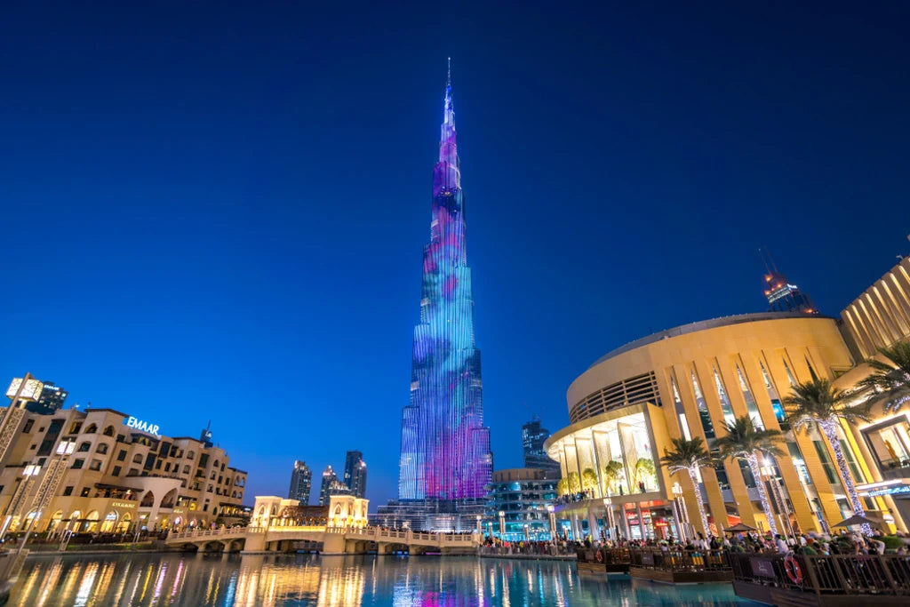 The Dubai Mall and the Burj Khalifa at night, across the Dubai Fountain lake