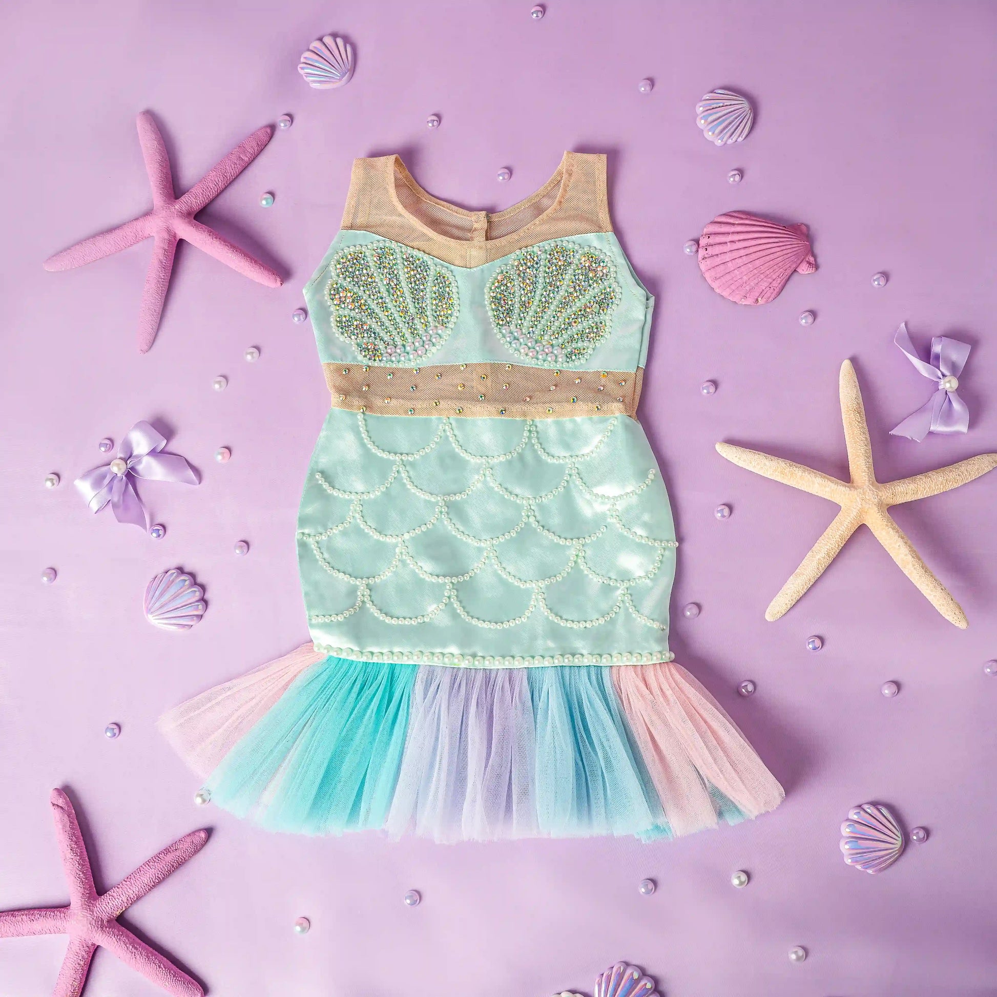 Mermaid-themed dress with starfish and shells on a purple background