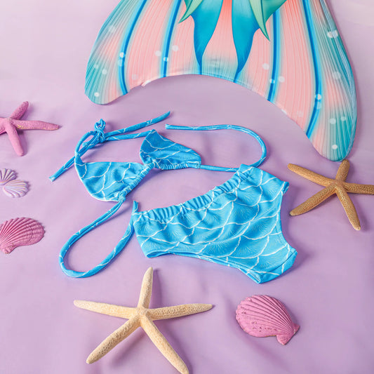 Blue mermaid-themed bikini set with starfish and shells on a pink background
