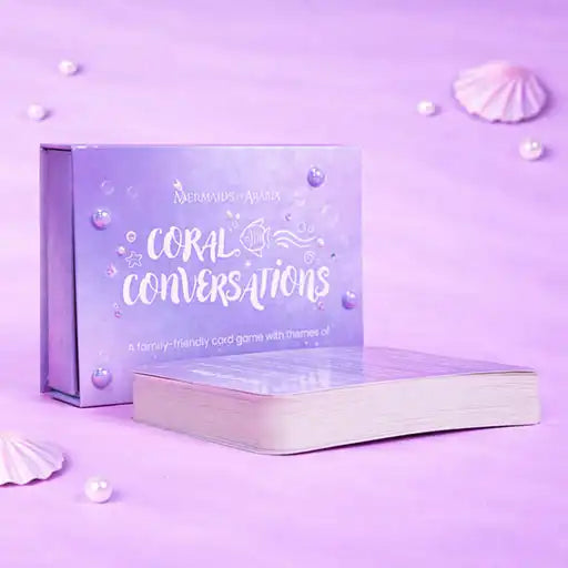 Card game box titled 'Coral Conversations' on a purple background with seashells and pearls.