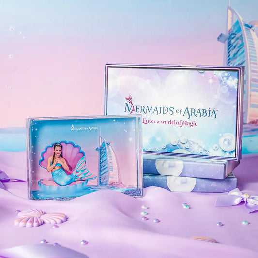Mermaids of Arabia product packaging with a mermaid illustration and Dubai skyline on a pastel background.