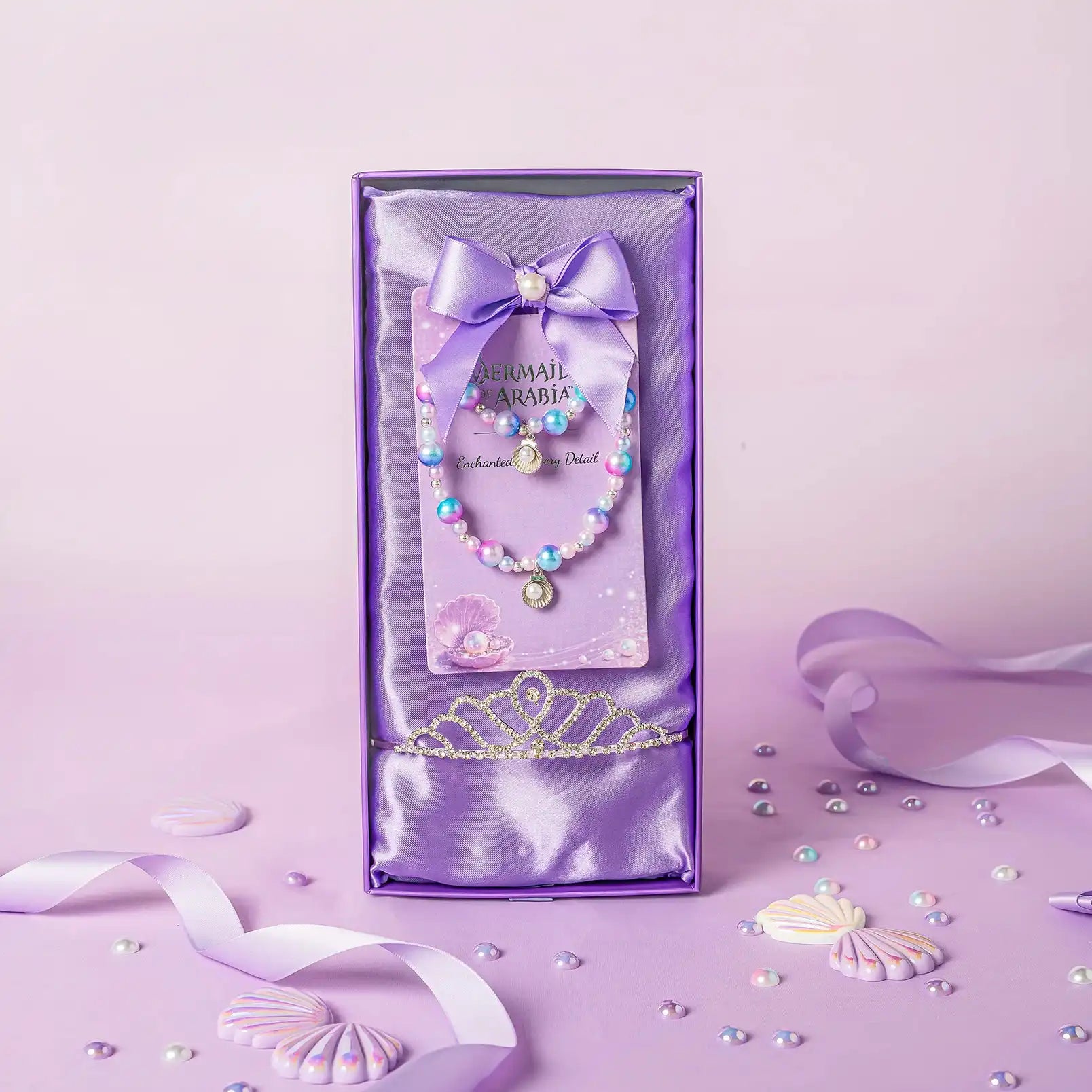 Purple gift box with a necklace and bow on a matching purple background