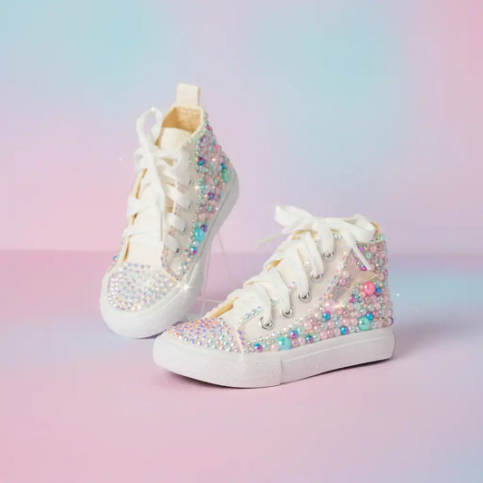 White high-top sneakers with colorful embellishments on a pastel gradient background