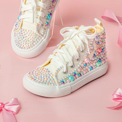 White sneakers with colorful embellishments on a pink background
