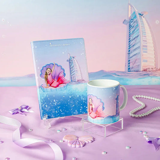 Mermaid-themed mug and notebook with a cityscape background