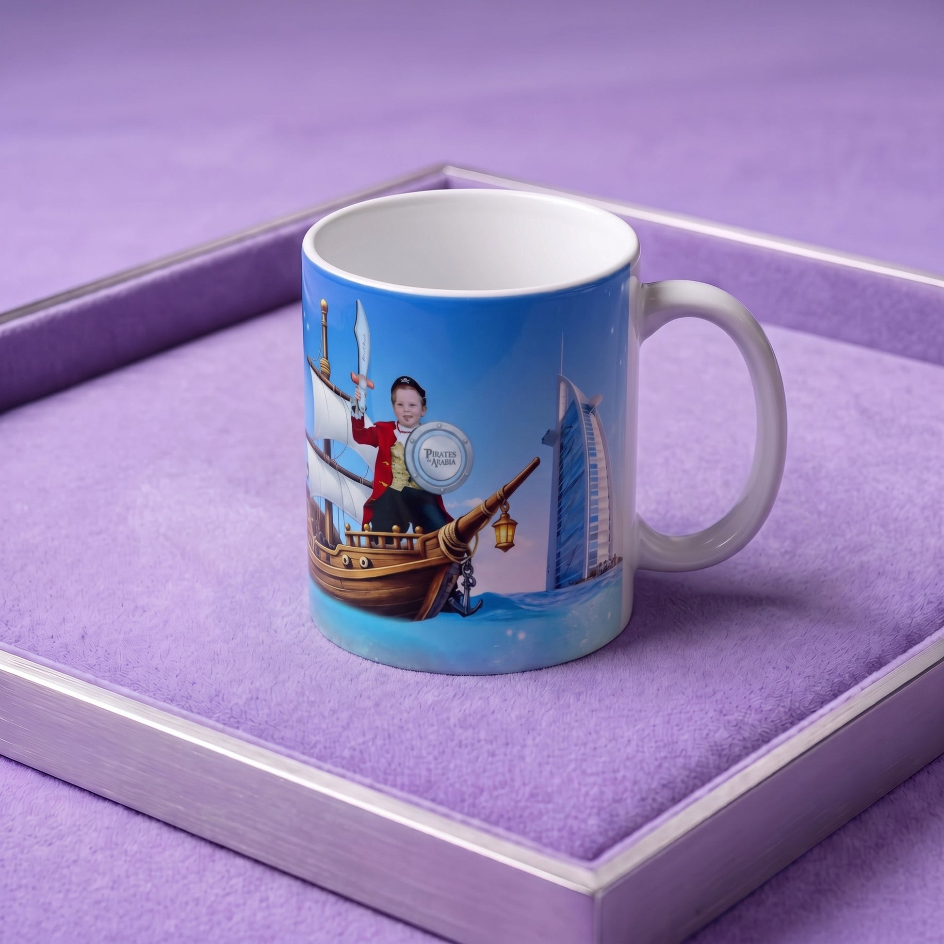 A custom printed ceramic mug with a blue pirate-themed illustration, displayed inside a purple velvet-lined presentation box.