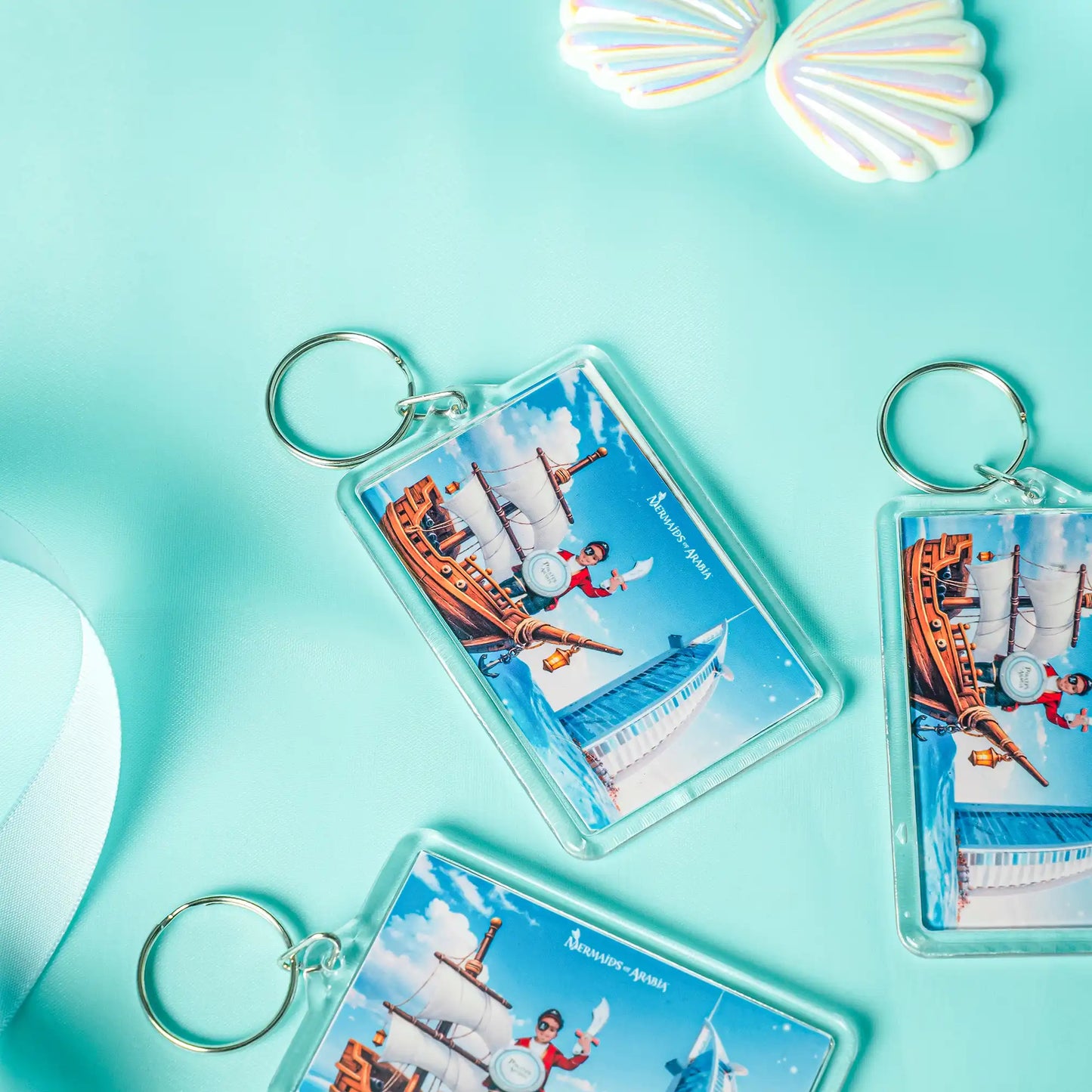 Keychains with a scenic design on a turquoise background