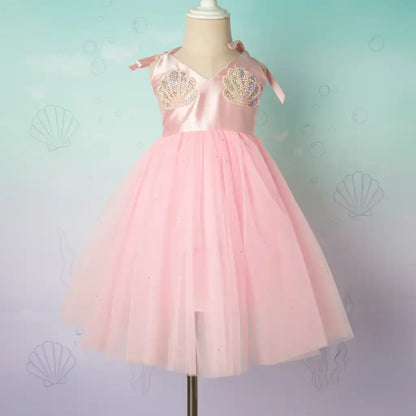 Pink dress with gold embellishments on a mannequin against a light blue background